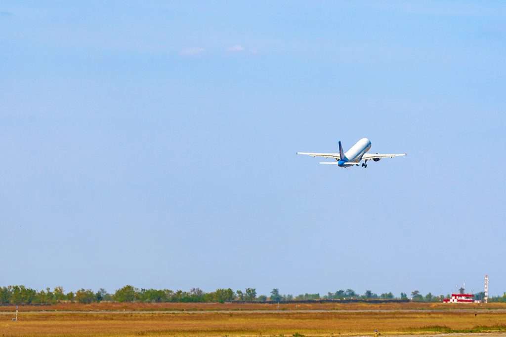 A passenger plane taking off from the runway in an airport