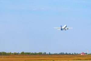A passenger plane taking off from the runway in an airport